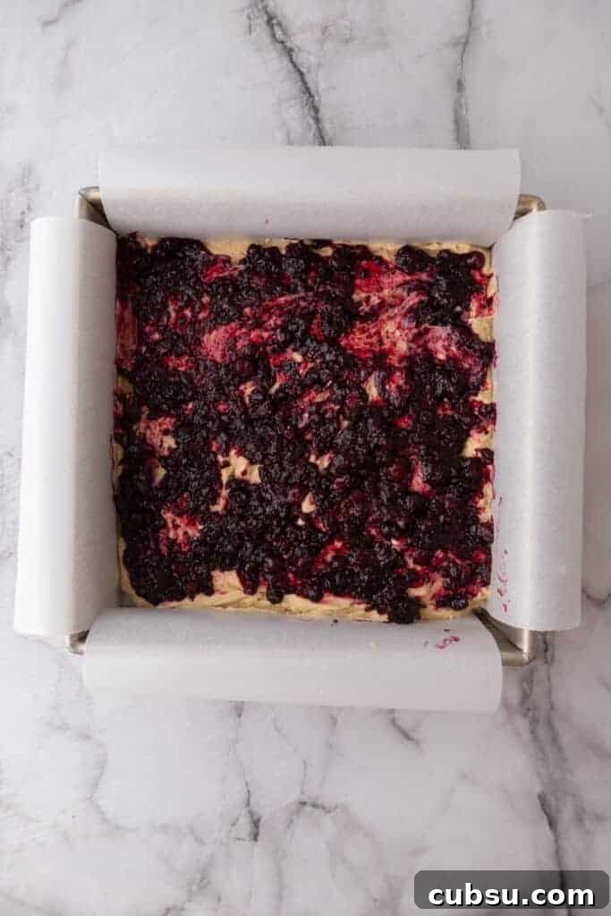 Chewy Blueberry Blondies Recipe with Lemon Glaze 9 mixed ingredients in a pan
