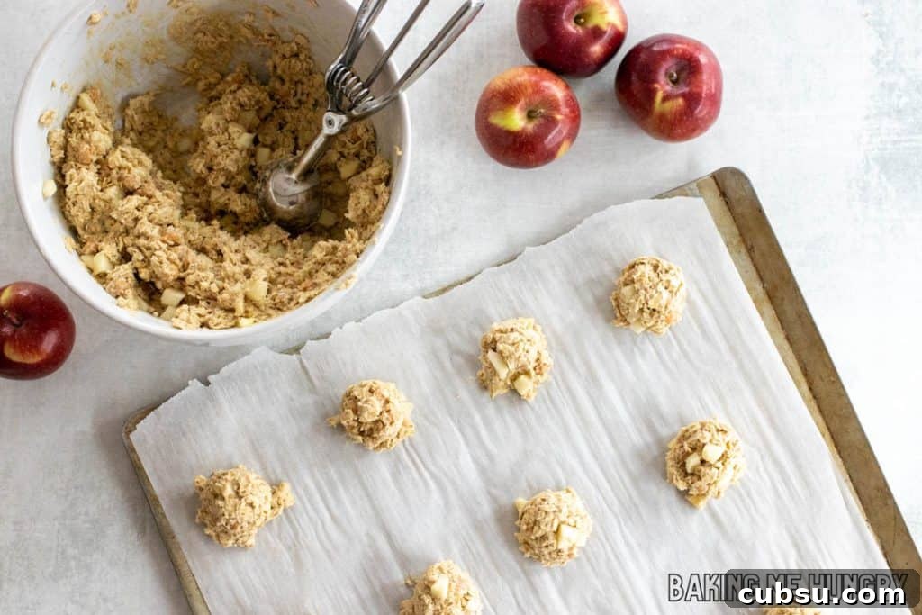 balls of dough being scooped onto parchment