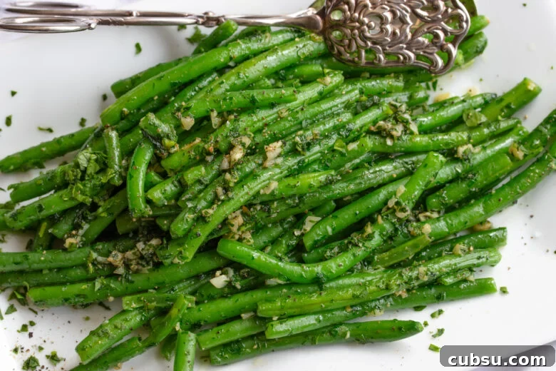Crispy Pan-Fried Green Beans with Garlic and Lemon Zest 8 pan fried green beans on a serving plate