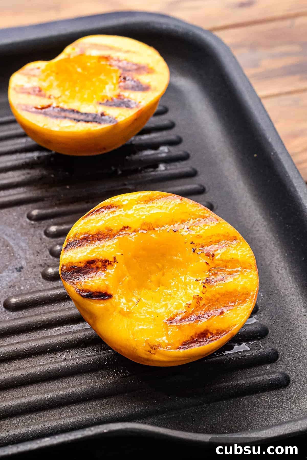 Grilled Peaches with Honey-Balsamic Glaze Recipe 7 Peaches with grill marks laying on grill pan