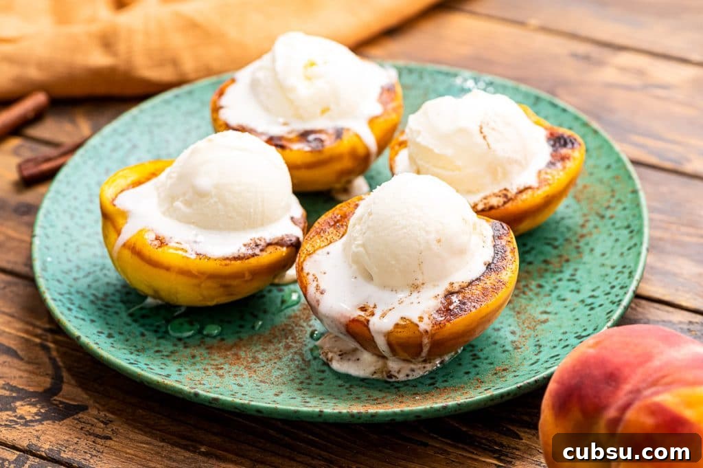 Grilled Peaches with Honey-Balsamic Glaze Recipe 8 Green plate with grilled peaches topped with ice cream on it.