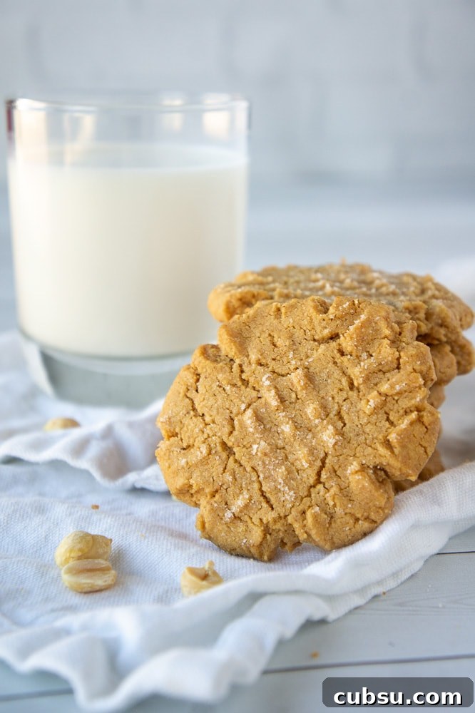 Flourless Peanut Butter Cookies Recipe — Chewy 3-Ingredient Treat 2 a stack of flourless peanut butter cookies in front of a glass of milk