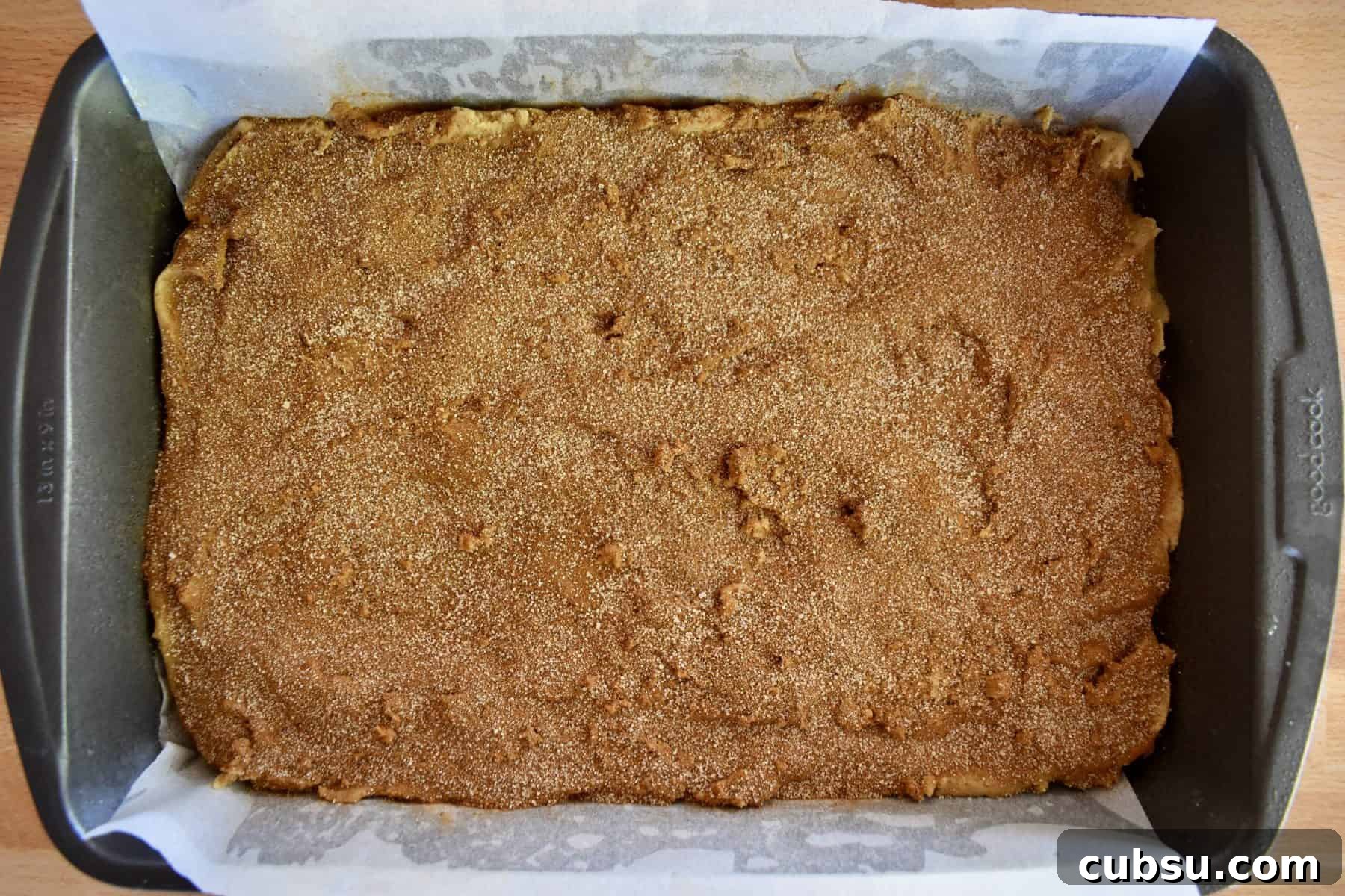 Chewy Cinnamon Sugar Blondies Recipe for Perfect Texture 7 sugar mixture sprinkled over top of the battle in the baking pan.