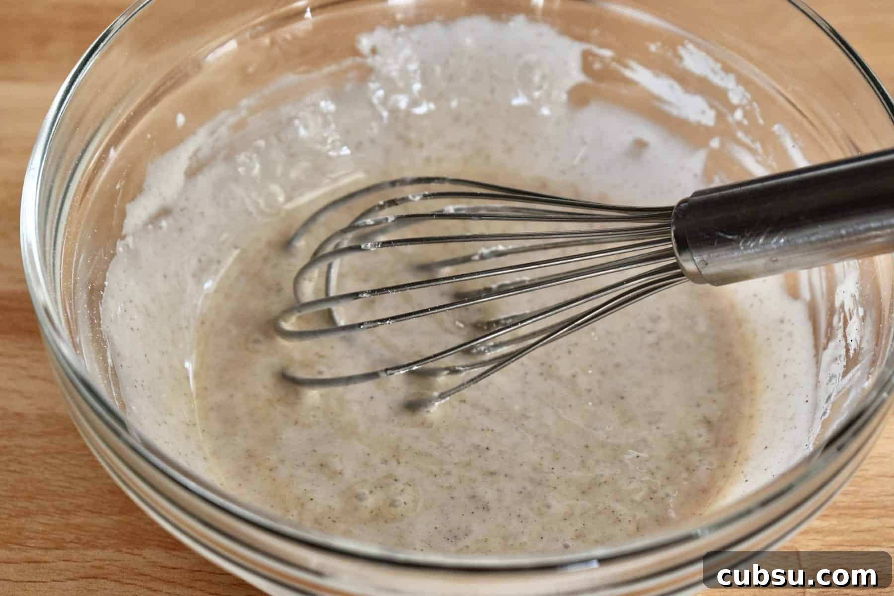 Chewy Cinnamon Sugar Blondies Recipe for Perfect Texture 9 glaze in a glass bowl with a whisk.