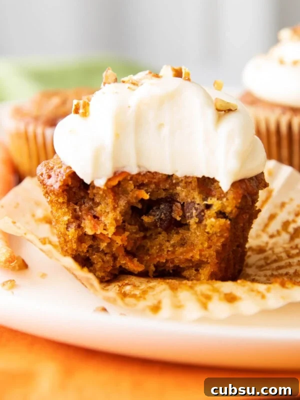 Classic Buttermilk Pound Cake Recipe with Tender Crumb 6 close up photo of the best carrot cake cupcakes with a bite taken out of it.