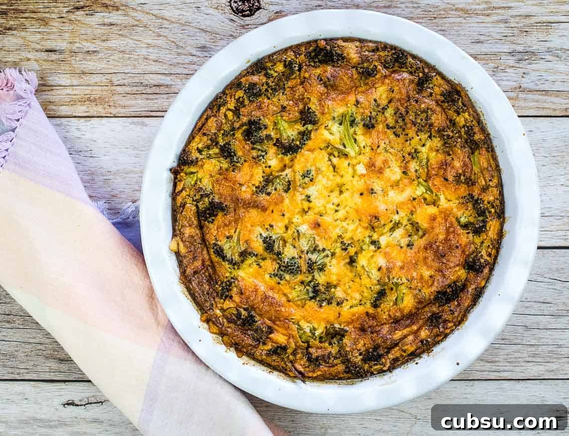 31 Classic Comfort Recipes That Keep Families Coming Back 30 A slice of Broccoli 3-Cheese Impossible Quiche on a white plate with a side of mixed fruit. A full quiche and glass of orange juice are in the background.