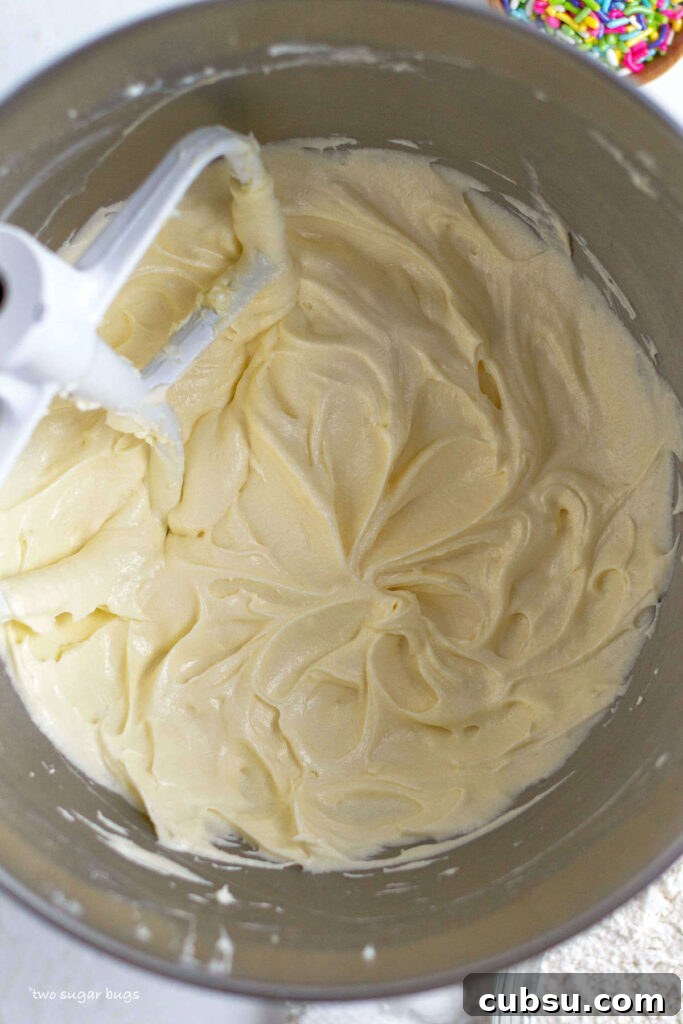 Cream Cheese Sugar Cookie Bars — Soft Frosted Dessert Bars 8 butter, sugar, eggs and cream cheese mixed to a batter in the mixing bowl