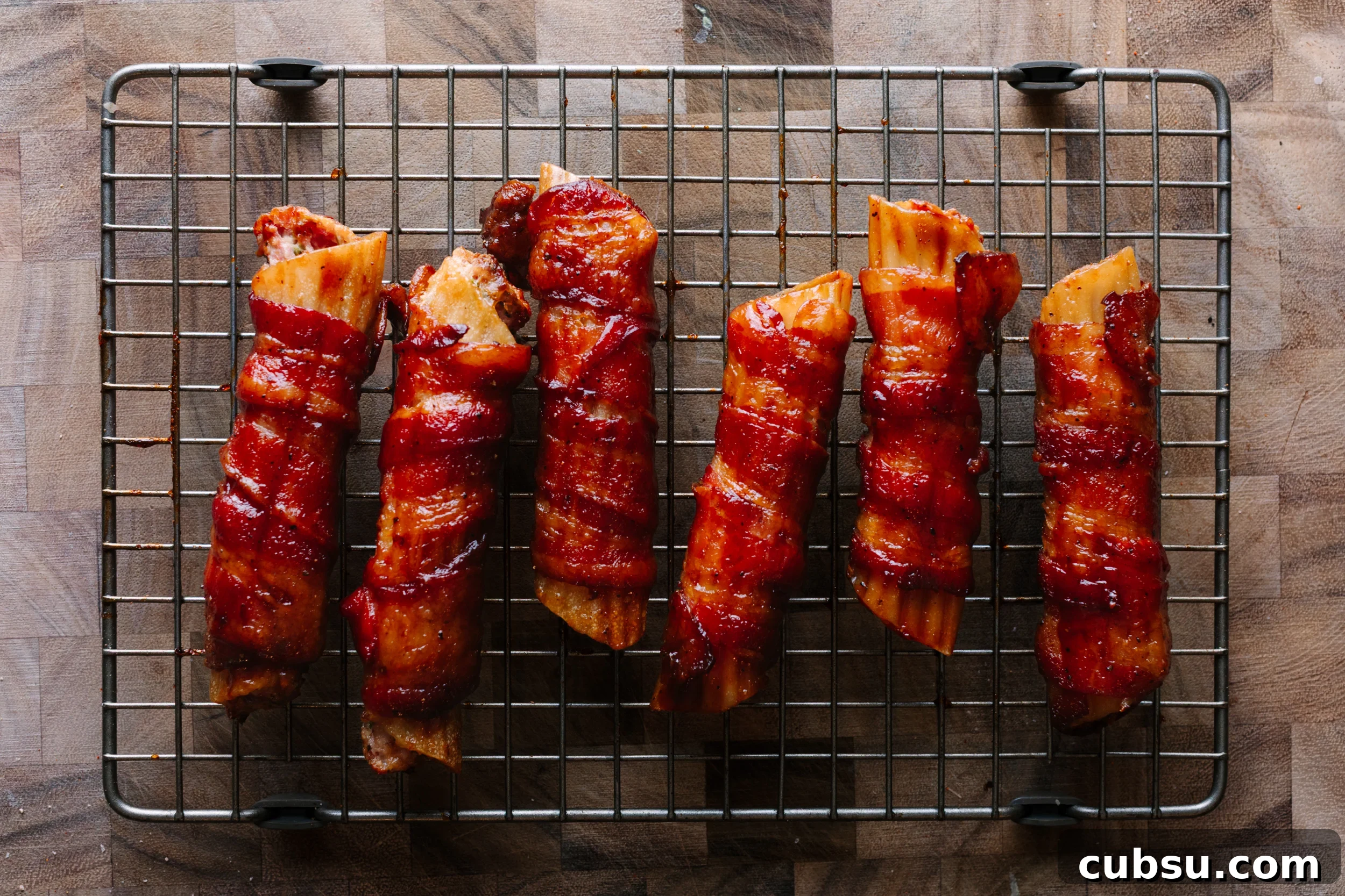 Smoked Shotgun Shells: How They're Made and What to Know 11 Smoked shotgun shells on a wire rack set over a cutting board.