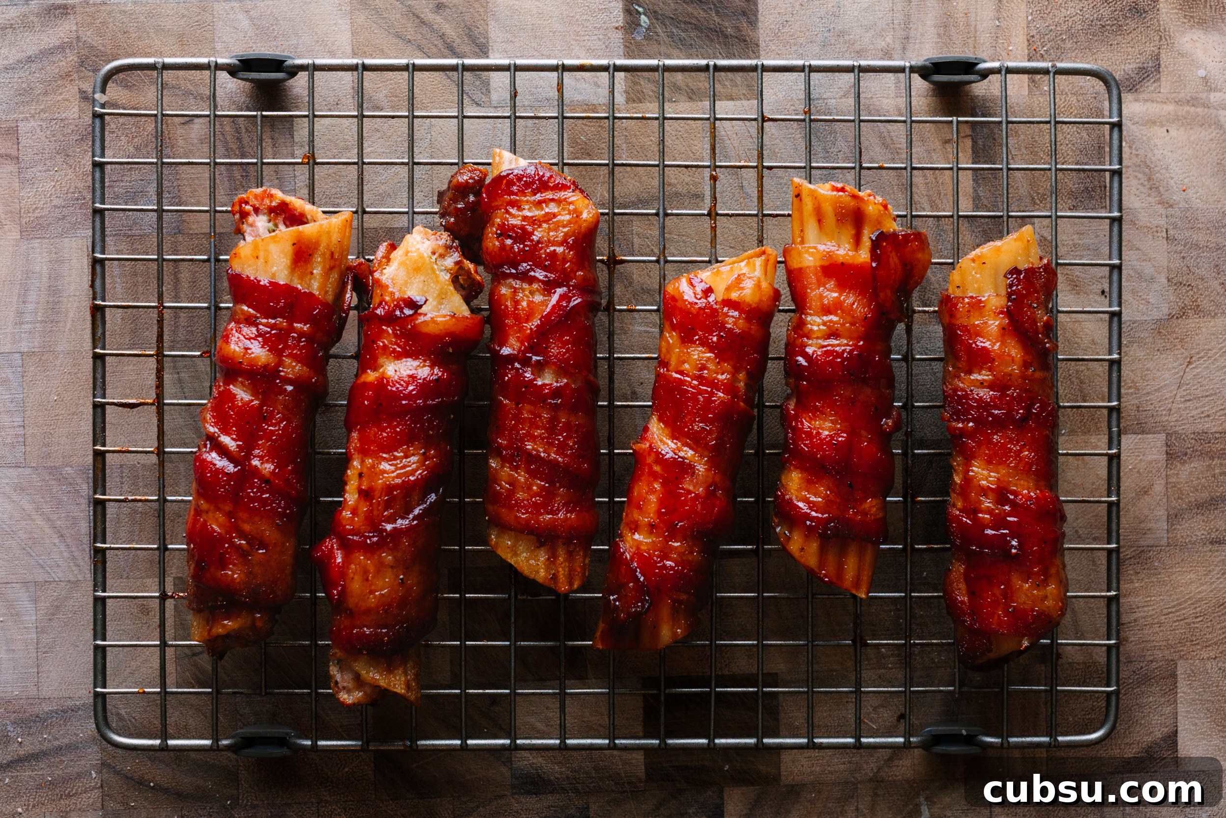 Smoked Shotgun Shells: How They're Made and What to Know 9 Smoked shotgun shells on a wire rack set over a cutting board.