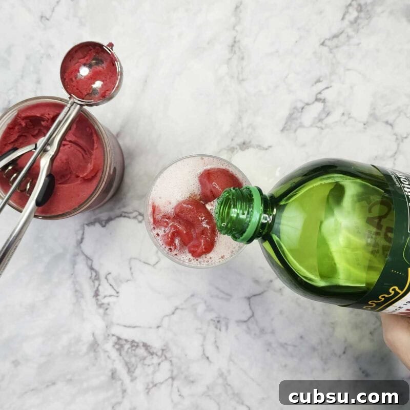 3-Ingredient Raspberry Spritz Cocktail Recipe 5 Process shot: add ginger ale to top off the glass.