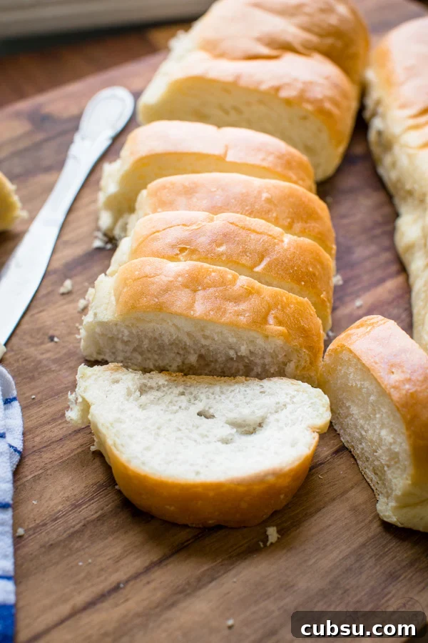 homemade french bread baguette with butter on cutting board