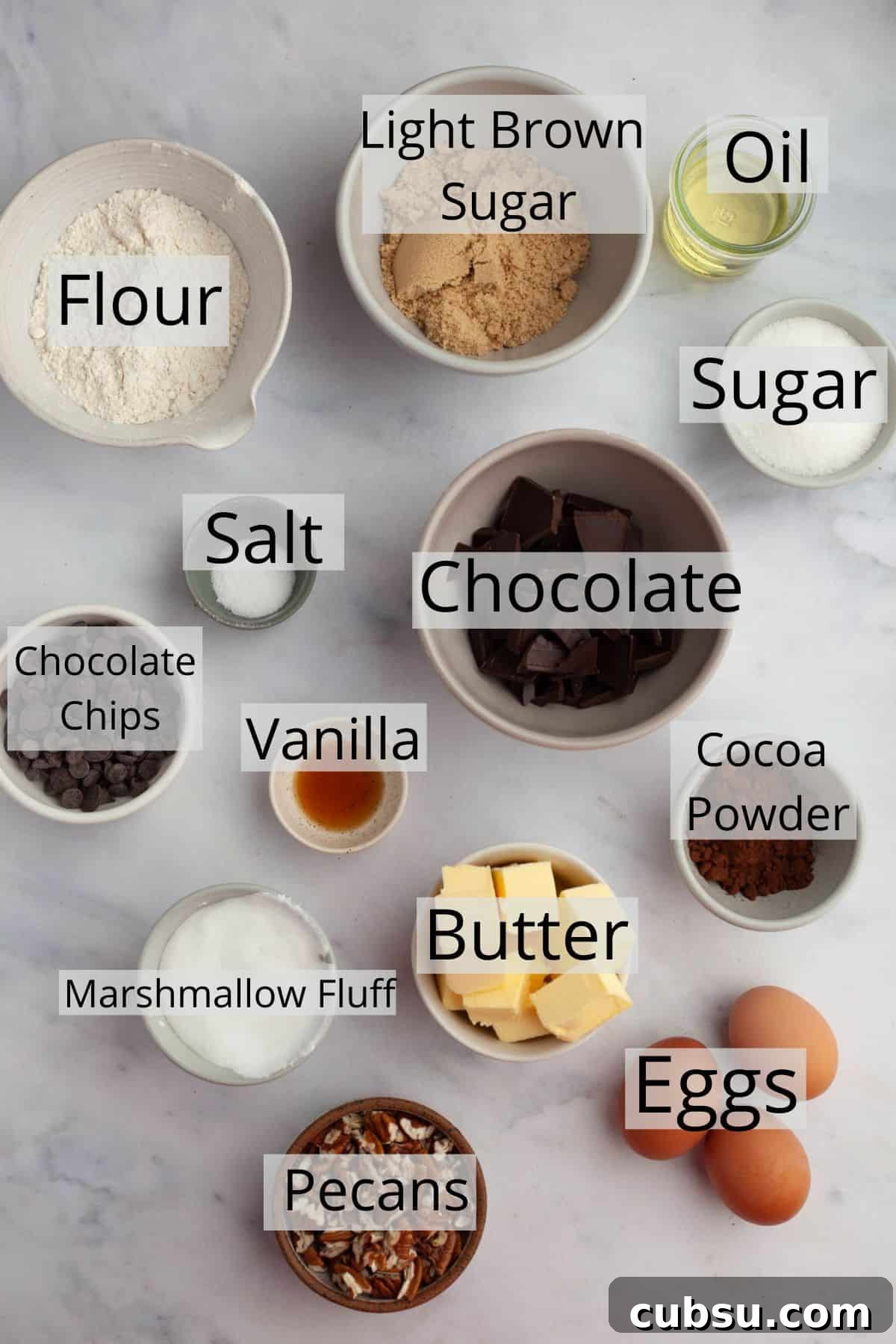 All the ingredients needed for marshmallow fluff brownies weighed out into small bowls.