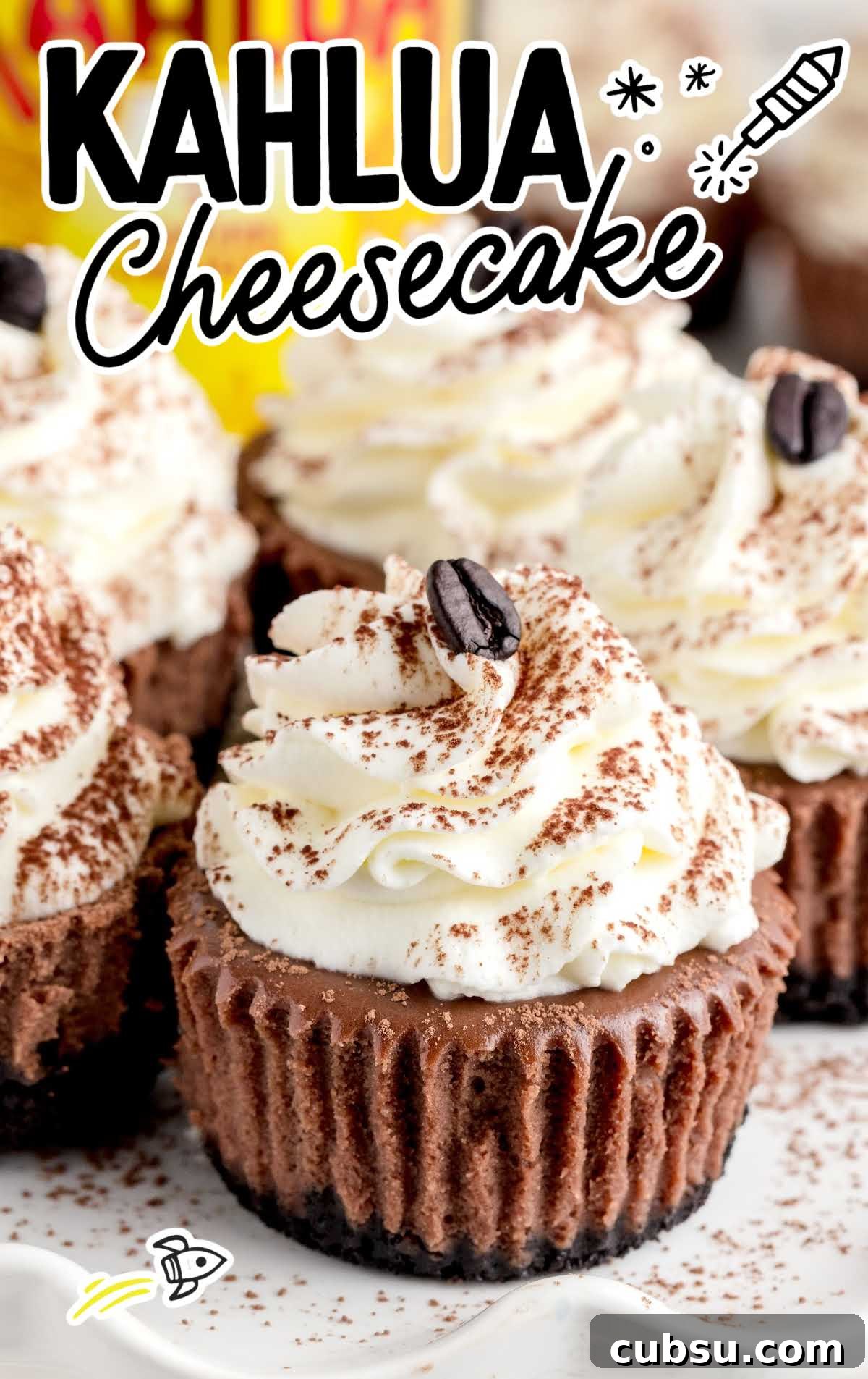 close up shot of Kahlua Cheesecake topped with frosting and sprinkled with cocoa on a cake stand