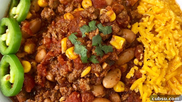 close up of overhead shot of taco chili in a white bowl with a jalapeno with cheese