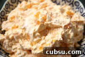 A serving bowl of orange tapioca jello salad.