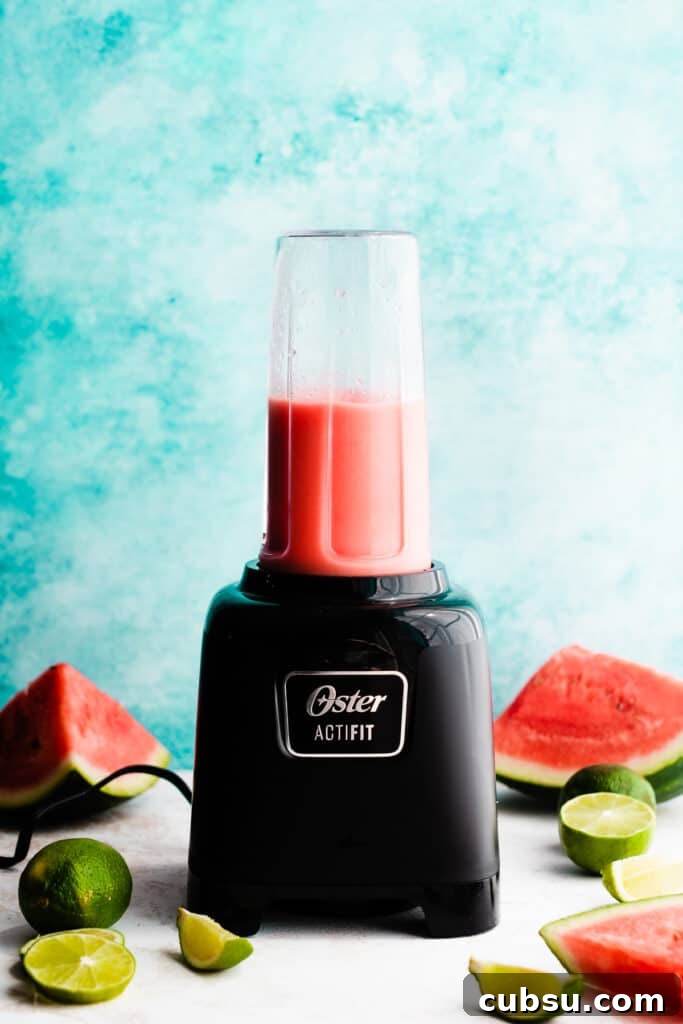 A blender with the blended margarita.
