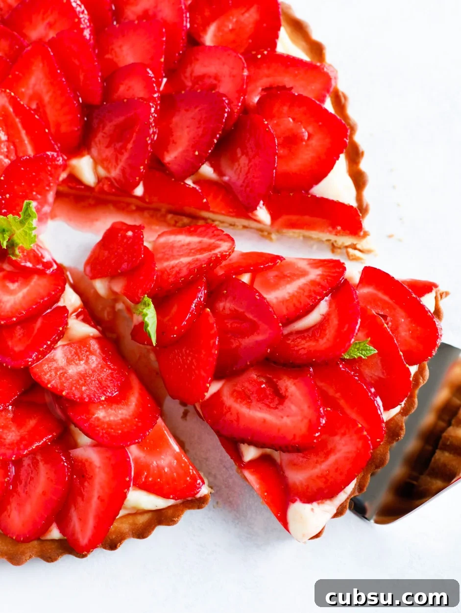 Strawberry French Tarte with a slice being taken out.