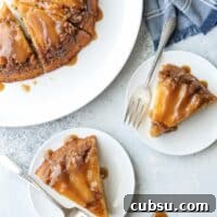 Two slices of caramel upside down cake on plates ready to eat