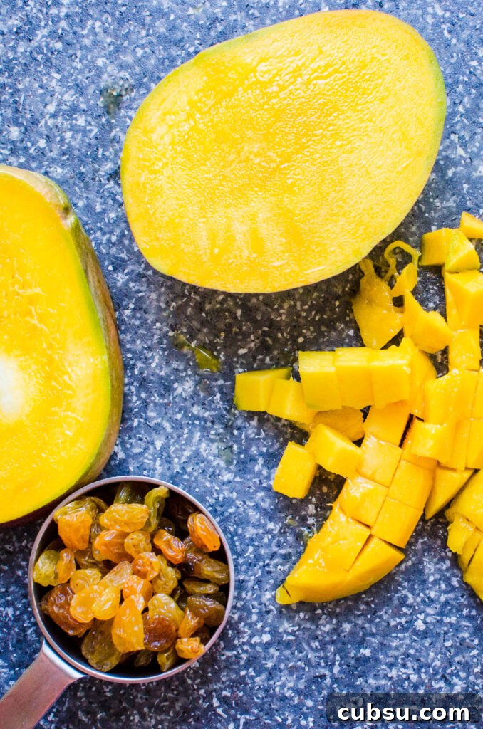 dicing mango and measuring out the golden raisins for the rice.