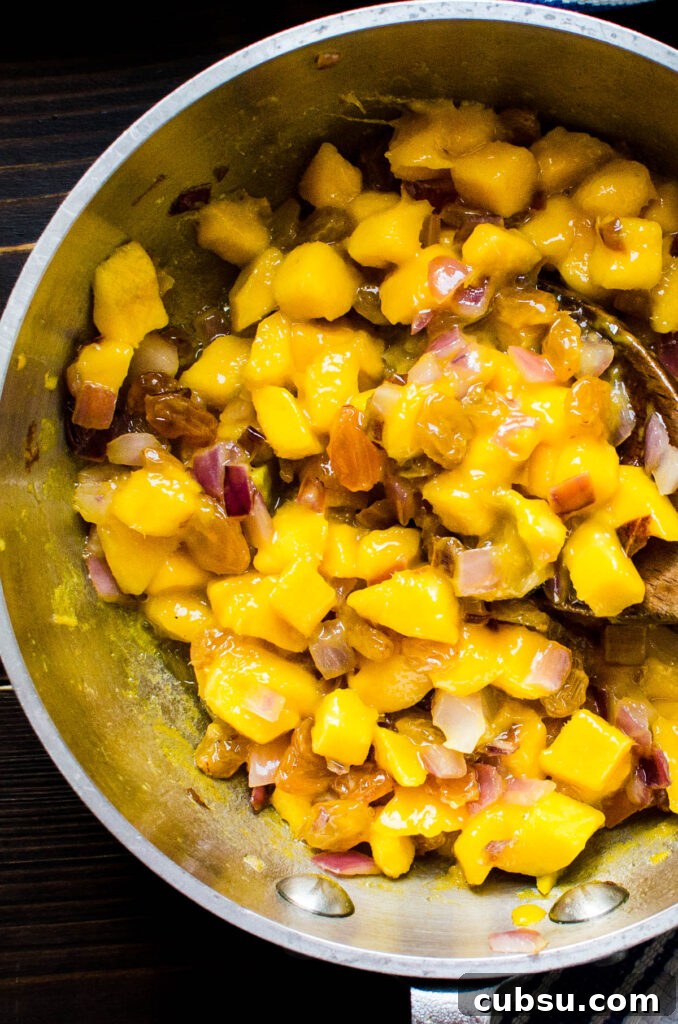 sautéing the mangoes with golden raisins and red onions.