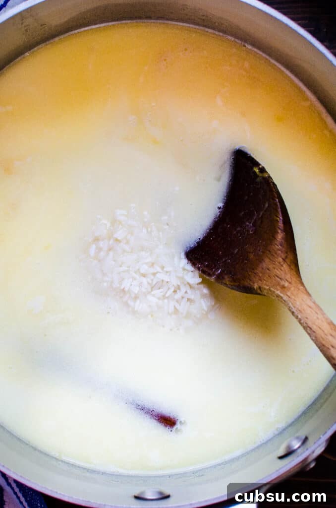 adding rice to coconut milk, water and orange juice mixture.