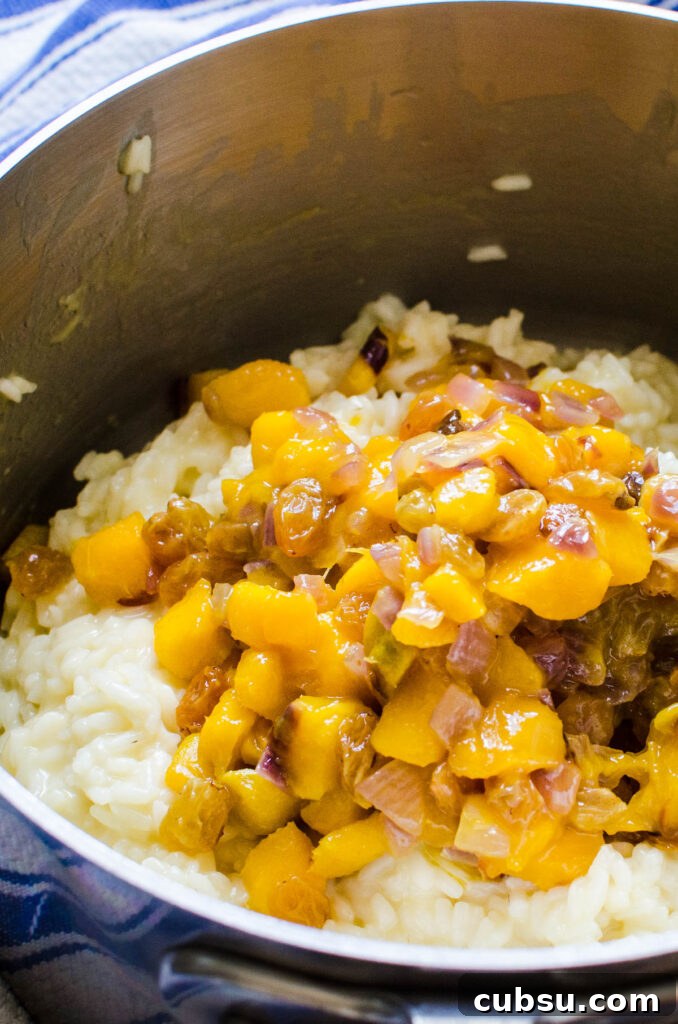adding sautéed mango, raisins and red onions to the coconut rice.