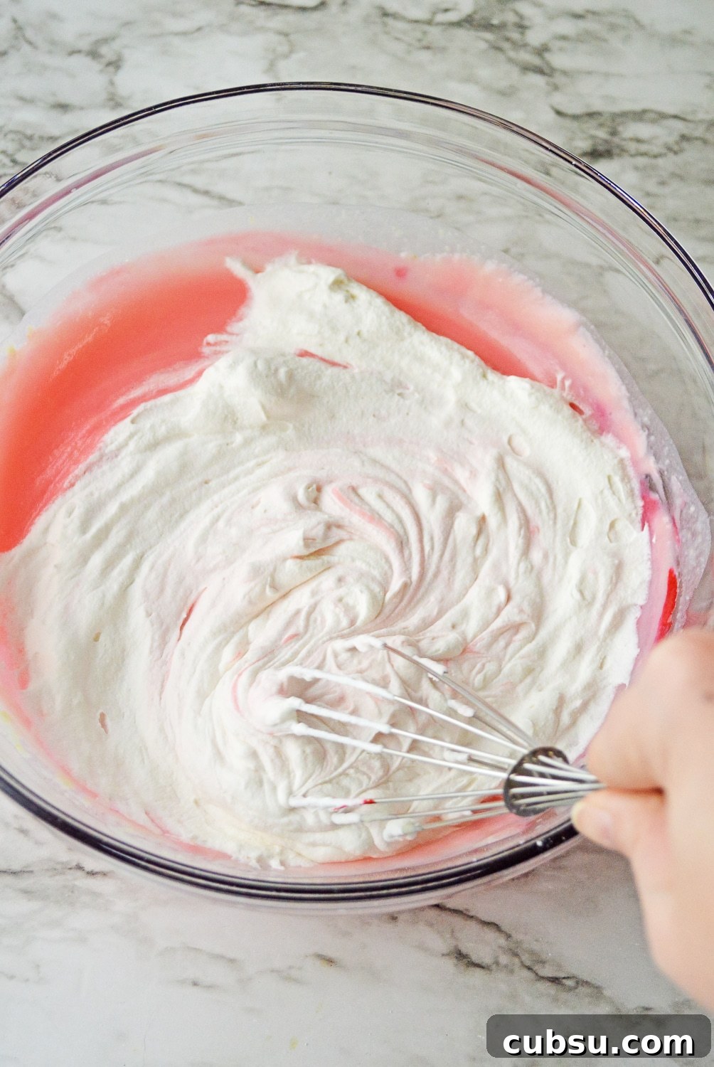 folding in whipped topping into pudding mixture