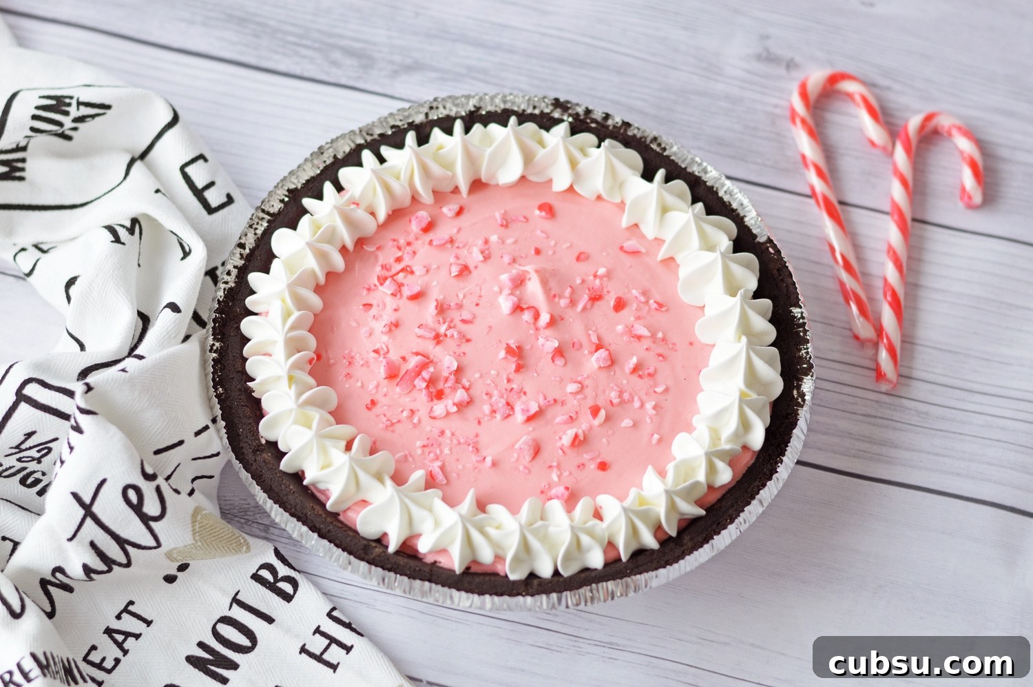 close shot of peppermint pie with candy canes in background 