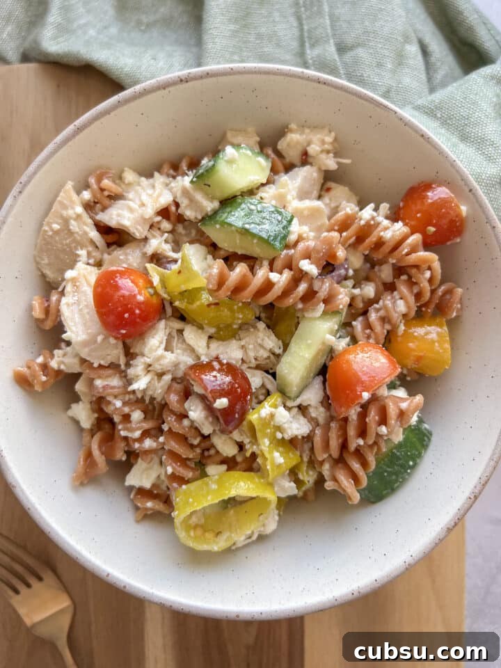 Close-up photo of high protein pasta salad in a small bowl, mixed.
