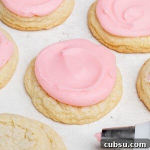 gluten free crumbl cookies sugar cookies with pink icing on white surface