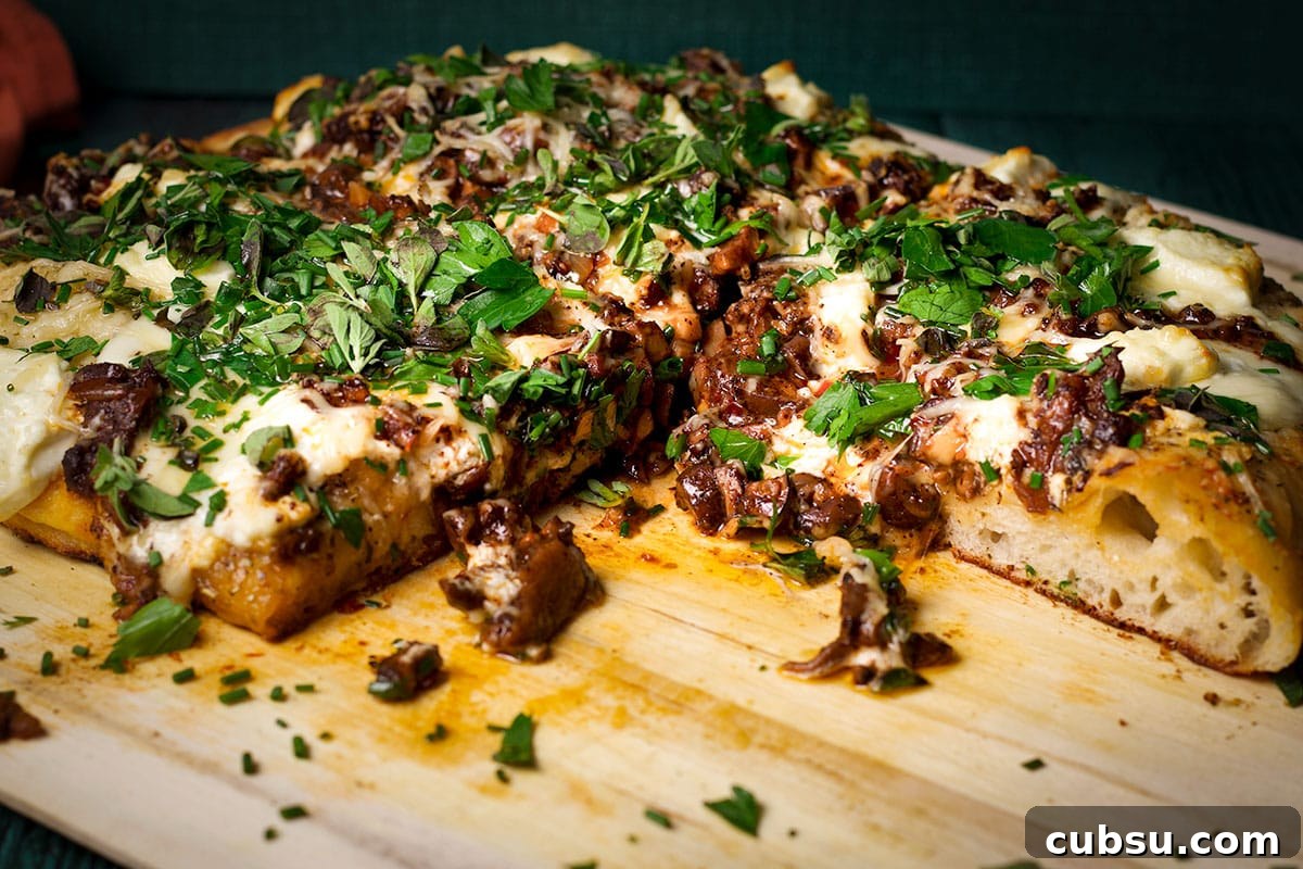 A partially eaten mushroom pizza made with homemade pizza crust.